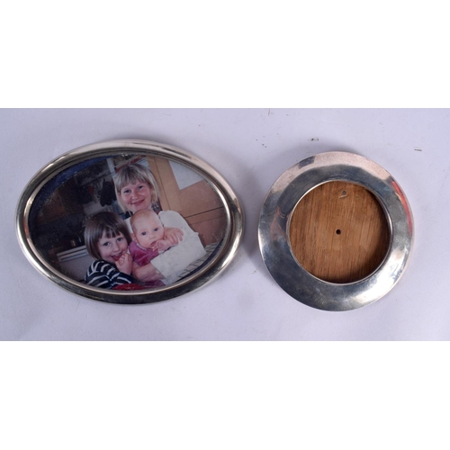 99 - THREE SILVER MOUNTED PHOTOGRAPH FRAMES together with two silver clocks. London 1921, 1970 & 1995. 67... 