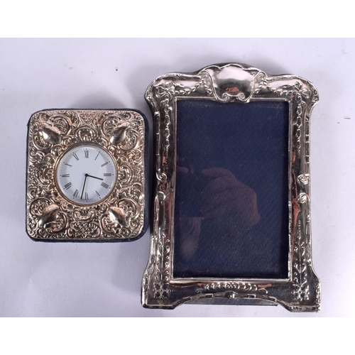 99 - THREE SILVER MOUNTED PHOTOGRAPH FRAMES together with two silver clocks. London 1921, 1970 & 1995. 67... 