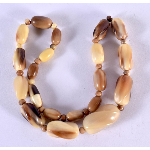 1280 - A CARVED HORN BEAD NECKLACE.  Length 46cm, largest bead 13.8mm