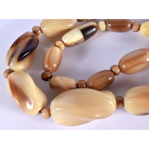 1280 - A CARVED HORN BEAD NECKLACE.  Length 46cm, largest bead 13.8mm