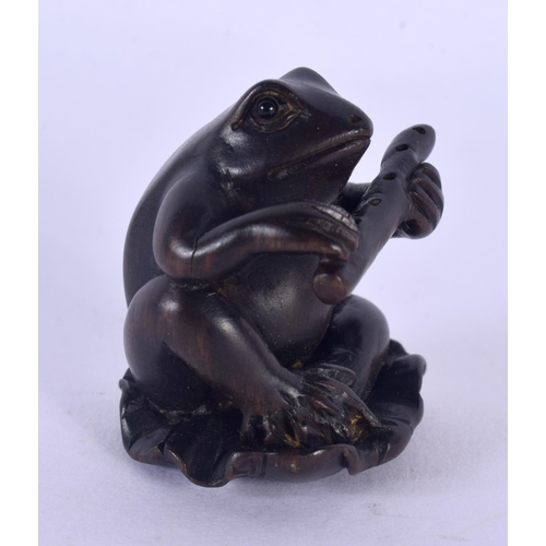 1532 - A JAPANESE CARVED BOXWOOD TOAD AND FLUTE NETSUKE. 4 cm x 2.5 cm.