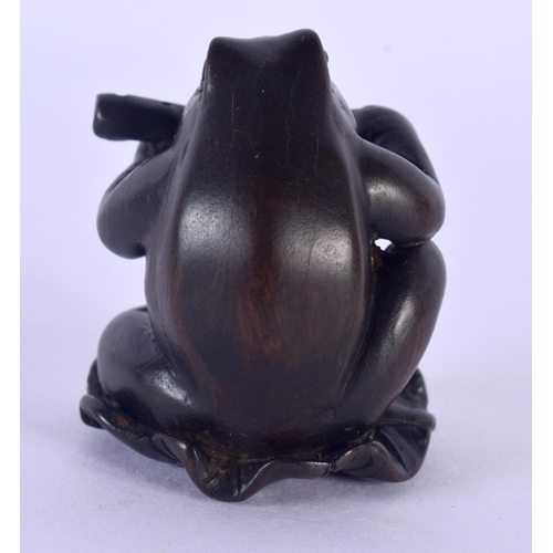 1532 - A JAPANESE CARVED BOXWOOD TOAD AND FLUTE NETSUKE. 4 cm x 2.5 cm.