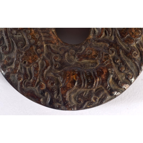 1549 - An 18TH / 19TH CENTURY CHINESE CARVED HARDSTONE BI DISK finely carved with Kylin, deer and tiger, 7c... 