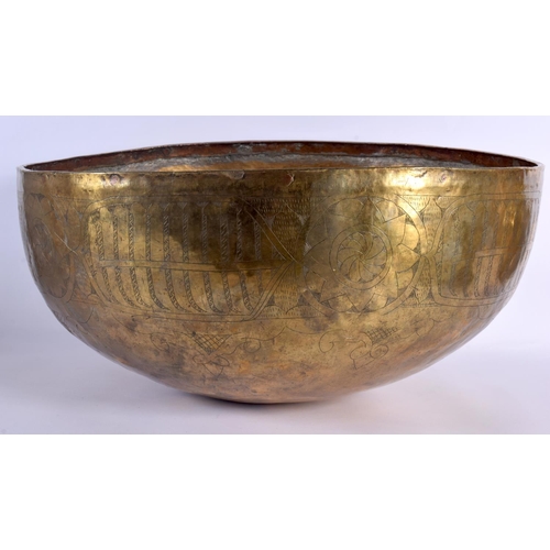 1553 - A 12TH / 13TH CENTURY CENTRAL ASIAN LARGE ENGRAVED CALLIGRAPHY BOWL hammered brass with engraved mot... 