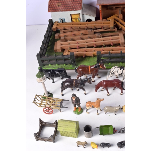 3677 - A vintage child's farm yard set with wooden buildings and a large collection of painted lead animals