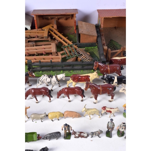 3677 - A vintage child's farm yard set with wooden buildings and a large collection of painted lead animals