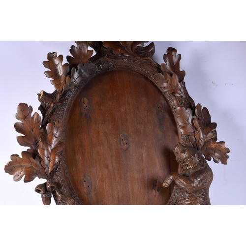 3750 - A carved black forest wooden  bear mirror surround 123 x 70 cm