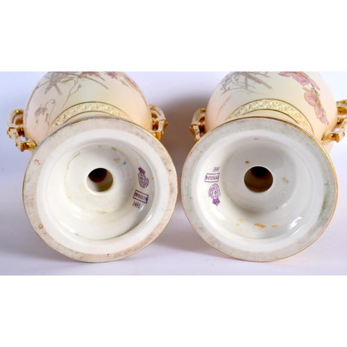 107 - A LARGE PAIR OF ROYAL WORCESTER TWIN HANDLED BLUSH IVORY VASES. 38 cm x 20 cm.