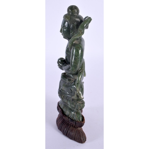 128 - A CHINESE QING DYNASTY CARVED SPINACH JADE IMMORTAL modelled clutching a censer. 15 cm x 7 cm.