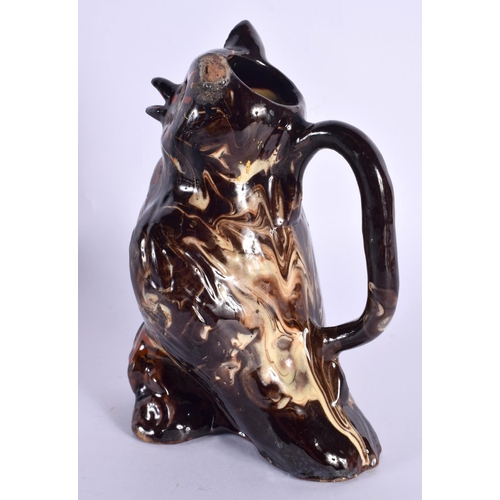 131 - A 19TH CENTURY TREACLE GLAZED POTTERY OWL JUG. 18 cm high.