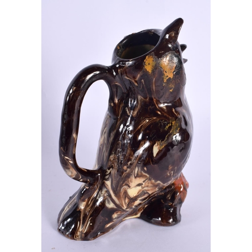 131 - A 19TH CENTURY TREACLE GLAZED POTTERY OWL JUG. 18 cm high.