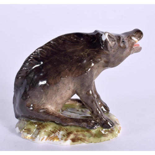 132 - A 19TH CENTURY GERMAN PORCELAIN FIGURE OF A BOAR modelled recumbent. 6.5 cm x 5.5 cm.