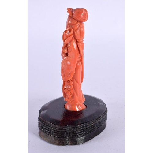 138 - A 19TH CENTURY CHINESE CARVED CORAL FIGURE OF A FEMALE HOLDING A FLORAL SPRIG.  11 cm high.