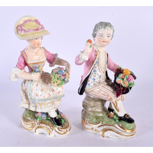 232 - DERBY PORCELAIN SEATED PAIR OF FIGURES, MODELLED AS A MAN WITH A HAT FILLED WITH FRUIT AND A WOMAN W... 