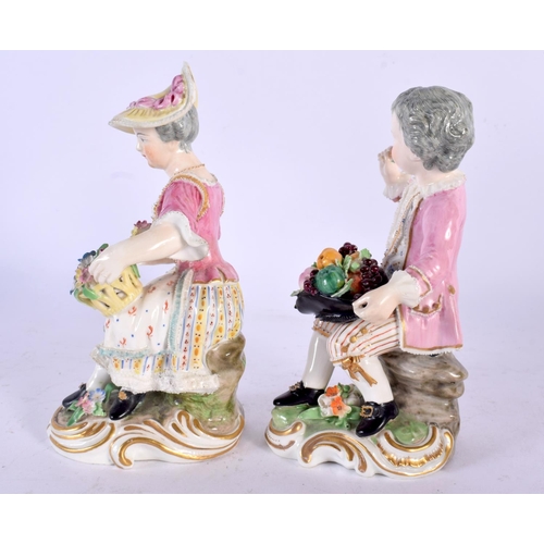 232 - DERBY PORCELAIN SEATED PAIR OF FIGURES, MODELLED AS A MAN WITH A HAT FILLED WITH FRUIT AND A WOMAN W... 