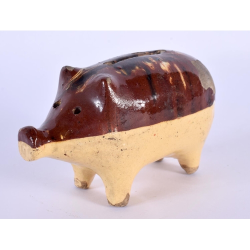 30 - A 19TH CENTURY ENGLISH TREACLE GLAZED POTTERY PIG MONEY BOX. 12 cm x 7 cm.