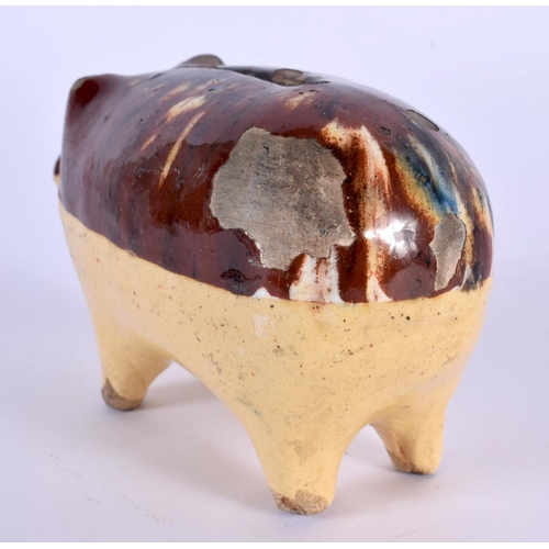 30 - A 19TH CENTURY ENGLISH TREACLE GLAZED POTTERY PIG MONEY BOX. 12 cm x 7 cm.