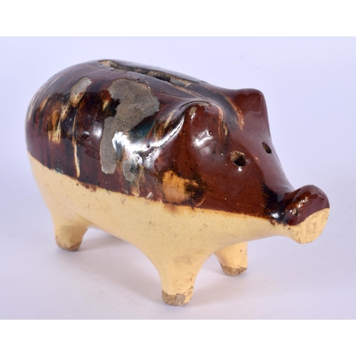 30 - A 19TH CENTURY ENGLISH TREACLE GLAZED POTTERY PIG MONEY BOX. 12 cm x 7 cm.