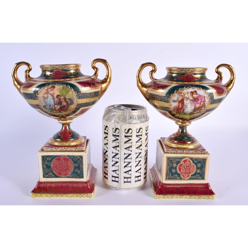 32 - A PAIR OF EARLY 20TH CENTURY VIENNA TWIN HANDLED PORCELAIN VASES decorated with figures. 18 cm x 12 ... 