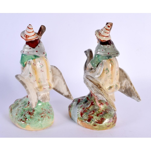 62 - A VERY RARE PAIR OF 19TH CENTURY STAFFORDSHIRE FIGURES OF WITCHES modelled riding upon swans. 20 cm ... 