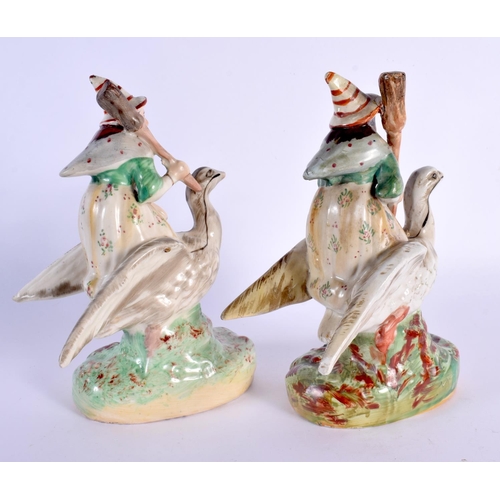 62 - A VERY RARE PAIR OF 19TH CENTURY STAFFORDSHIRE FIGURES OF WITCHES modelled riding upon swans. 20 cm ... 