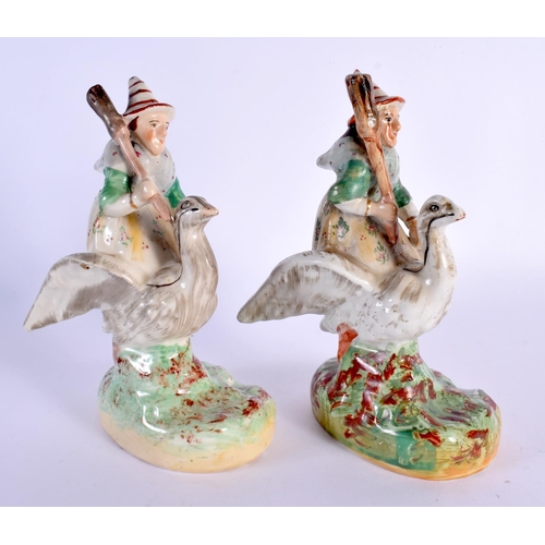 62 - A VERY RARE PAIR OF 19TH CENTURY STAFFORDSHIRE FIGURES OF WITCHES modelled riding upon swans. 20 cm ... 