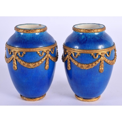 70 - AN UNUSUAL PAIR OF FRENCH SEVRES PORCELAIN BLUE VASES with gilt metal mounts. 8 cm high.