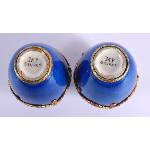 70 - AN UNUSUAL PAIR OF FRENCH SEVRES PORCELAIN BLUE VASES with gilt metal mounts. 8 cm high.