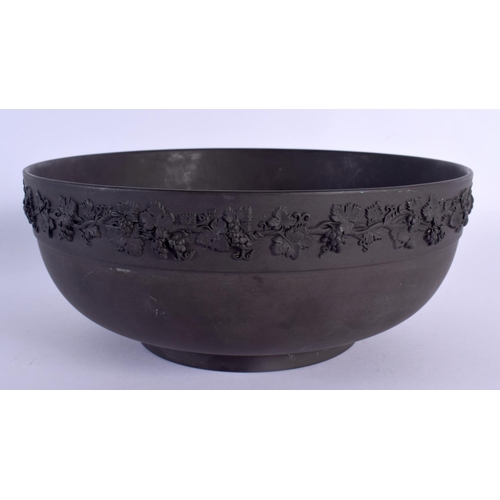 82 - A LARGE WEDGWOOD BLACK BASALT BOWL decorated with swags. 25 cm diameter.