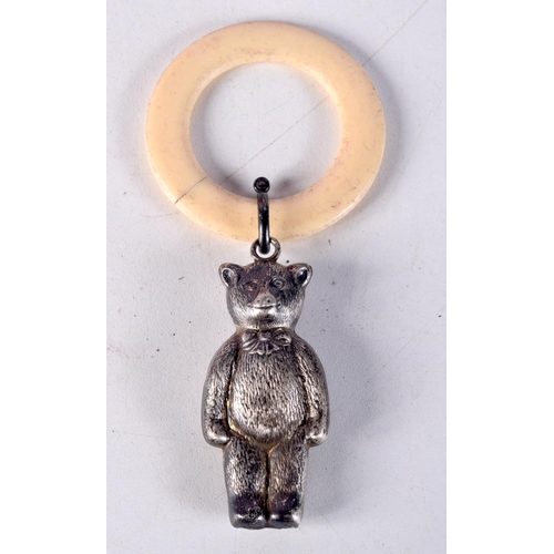 770A - AN ANTIQUE BONE TEETHING RING WITH A RATTLE IN THE FORM OF A BEAR.    11.4cm x 5.3cm, weight 15g