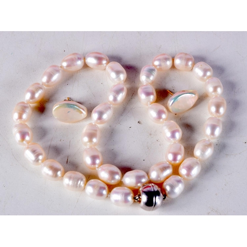 775E - A CULTURED PEARL NECKLACE TOGETHER WITH A PAIR OF 9CT GOLD BACKED PEARL EARRINGS.  Necklace 45cm lon... 