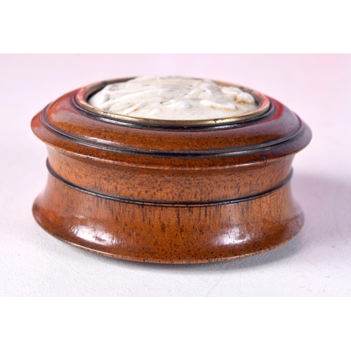 780B - A TURNED WOOD PILL BOX WITH A STONE CAMEO INSERT.  4.7cm x 2.4cm