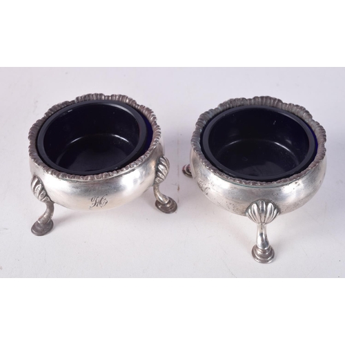 792 - A PAIR OF VICTORIAN SILVER SALTS WITH BLUE GLASS LINERS.  Hallmarked London 1840.  4cm x 6.2cm, weig... 