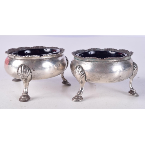 792 - A PAIR OF VICTORIAN SILVER SALTS WITH BLUE GLASS LINERS.  Hallmarked London 1840.  4cm x 6.2cm, weig... 