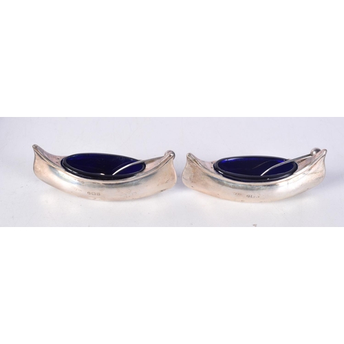 806 - A CASED PAIR OF EDWARDIAN SILVER BOAT SHAPED SALTS WITH BLUE GLASS LINERS.   Hallmarked Birmingham 1... 