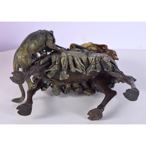 817 - A COLD PAINTED BRONZE IN THE BERGMAN STYLE OF A LION ATTACKING AN ARAB MOUNTED ON A CAMEL.  17cm x 1... 