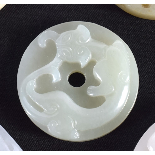 1503 - A GROUP OF NINE 19TH/20TH CENTURY CHINESE CARVED JADE BI DISCS in various forms and sizes. Largest 6... 