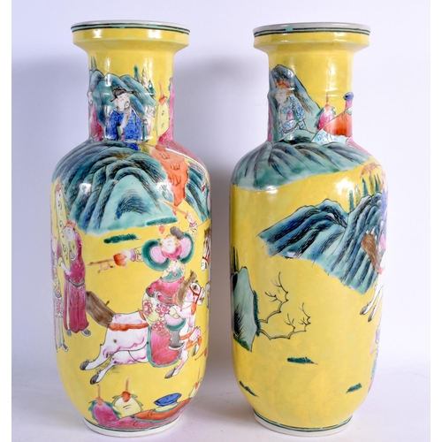 1563 - A RARE PAIR OF 19TH CENTURY CHINESE FAMILLE JAUNE PORCELAIN ROULEAU VASES Qing, painted with warrior... 