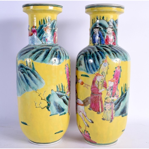 1563 - A RARE PAIR OF 19TH CENTURY CHINESE FAMILLE JAUNE PORCELAIN ROULEAU VASES Qing, painted with warrior... 