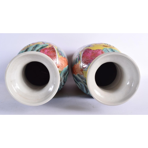 1563 - A RARE PAIR OF 19TH CENTURY CHINESE FAMILLE JAUNE PORCELAIN ROULEAU VASES Qing, painted with warrior... 