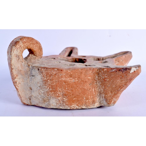 1569 - AN UNUSUAL 11TH/12TH CENTURY MIDDLE EASTERN POTTERY TRIPLE SPOUT LAMP. 15 cm x 13 cm.