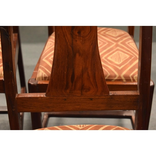 1604 - AN EARLY 20TH CENTURY CHINESE CARVED HEAVY HARDWOOD DINING TABLE with eight matching chairs, the tab... 