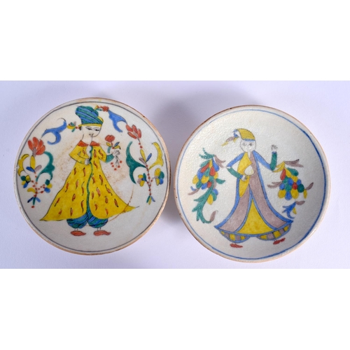 1621 - A PAIR OF TURKISH KUTAHYA POTTERY PLATES painted with figures. 14 cm diameter.