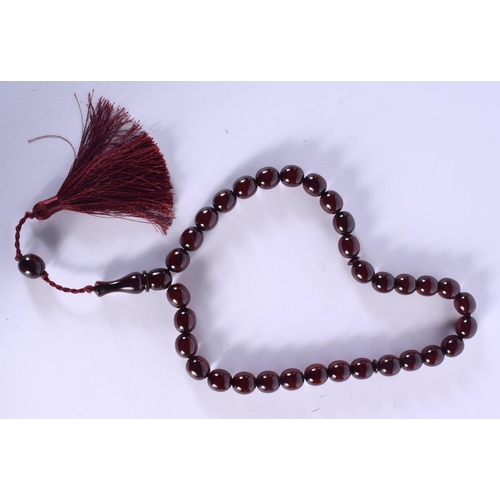 1642 - A STRING OF TURKISH RED AMBER TYPE PRAYER BEADS. 88 cm long.