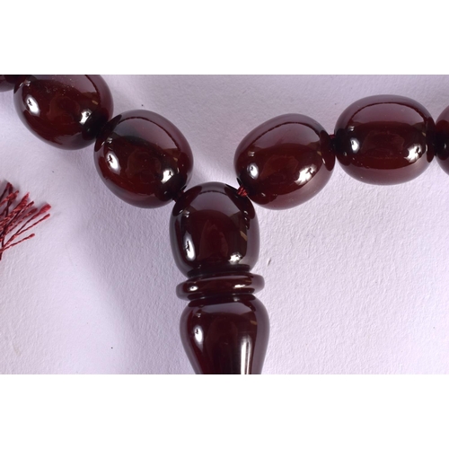 1642 - A STRING OF TURKISH RED AMBER TYPE PRAYER BEADS. 88 cm long.