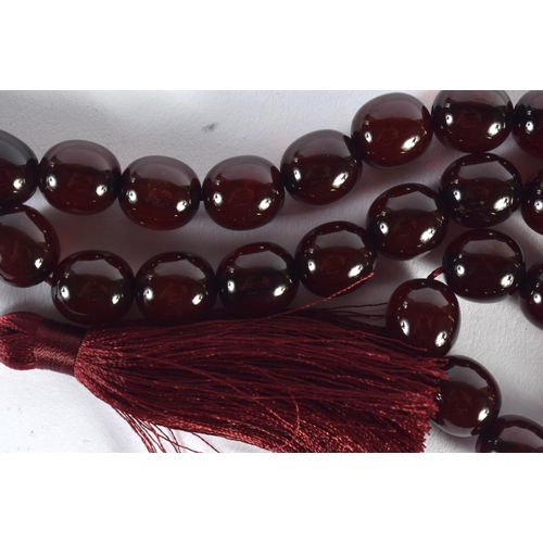 1642 - A STRING OF TURKISH RED AMBER TYPE PRAYER BEADS. 88 cm long.