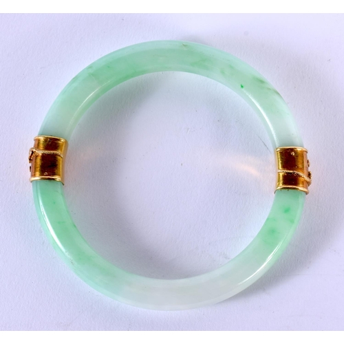 1704 - A GOOD 19TH CENTURY CHINESE JADEITE AND YELLOW METAL BANGLE. 85.4 grams. 7 cm internal diameter.