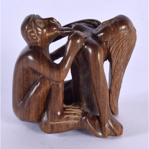 1716 - A JAPANESE CARVED WOOD EROTIC NETSUKE. 4.5 cm x 4.25 cm.