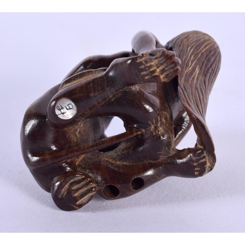 1716 - A JAPANESE CARVED WOOD EROTIC NETSUKE. 4.5 cm x 4.25 cm.