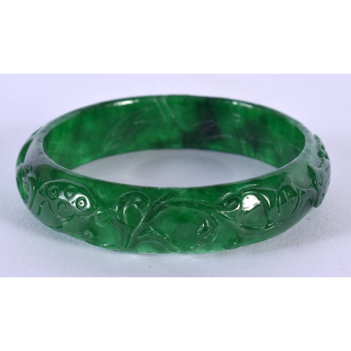 1720 - A CHINESE CARVED SPINACH JADE BANGLE 20th Century. 44.4 grams. 5.75 cm wide.